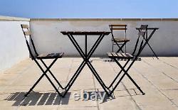 Ensemble de table et chaises de jardin en bois pour bistrot avec cadre métallique noir et pliable pour l'extérieur.